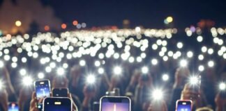 What Happens During a Rocket Launch? A Complete Guide Crowd filming rocket launch glow through phone screens