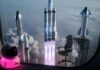How Private Space Companies Are Disrupting the Space Industry Heavy rocket mid-launch with blue plasma flames
